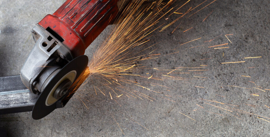 Close up angle grinder. Iron gate repair Close up angle grinder. Iron gate repair